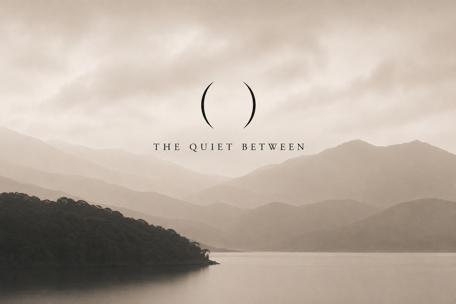 Misty mountains over a still lake